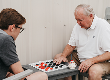 Play a game of checkers on the patio